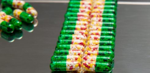 Medicinal capsules on a tray.