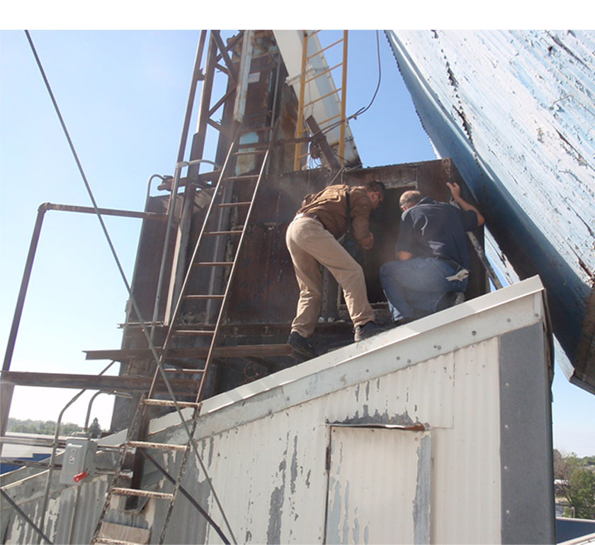 Engineers inspecting a dust collector.